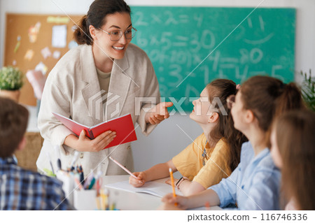 Happy kids and teacher at school 116746336