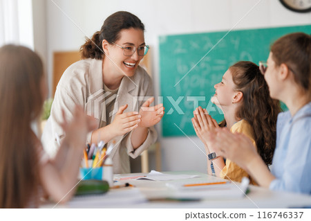 Happy kids and teacher at school 116746337