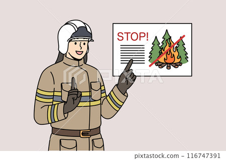 Man firefighter reminds of ban on lighting fires in forest, standing in work uniform and helmet 116747391