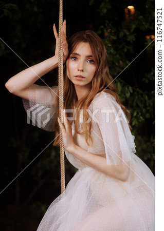 Elegant woman on wooden swing. Elegant woman on wooden swing. 116747521