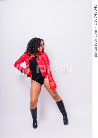 African oversize woman with boxing gloves on studio background, beautiful dark-skinned female boxer 116748040