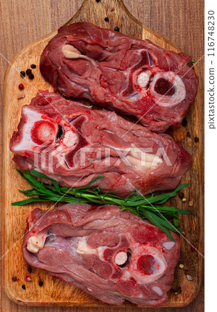 raw steak, calf's neck on the bone, fresh meat, on the cutting board, top view, no people, raw steak, calf's neck on the bone, fresh meat, on the cutting board, top view, no people, 116748230