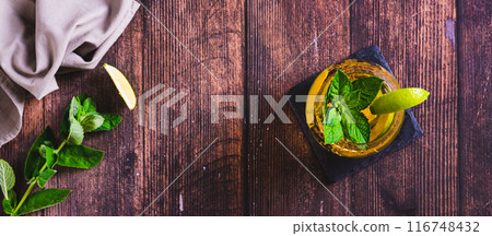 Summer detox drink with tea, lime and mint in glasses on the table top view web banner Summer detox drink with tea, lime and mint in glasses on the table top view web banner 116748432