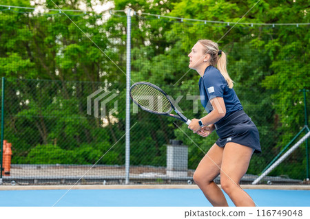 Professional female tennis player playing the tennis on outside court Professional female tennis player playing the tennis on outside court 116749048
