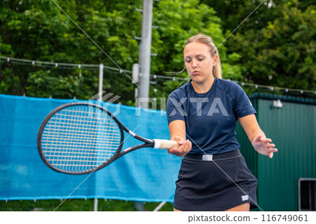 Professional female tennis player playing in tennis with racket and ball on outside court 116749061