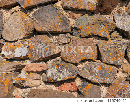 Closeup of an ancient stone wall texture 116749411
