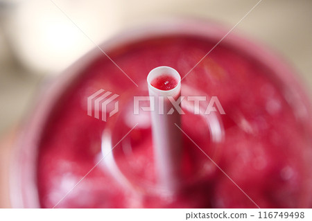 macro shot of straw full of red berries smoothie macro shot of straw full of red berries smoothie 116749498