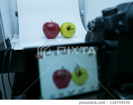 Camera photographing apples in the studio light box 116749530