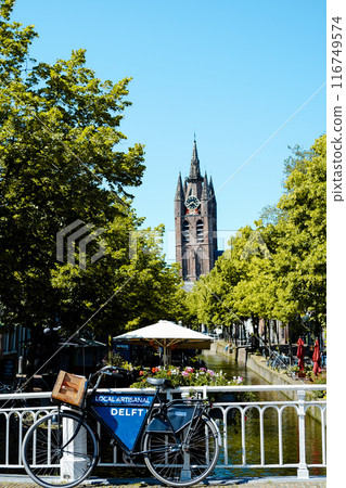 View of the brick tower of the Oude Kerk church and Delft's beautiful canals. 116749574