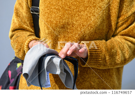 stylishly dressed young woman wipes sunglasses with microfiber, close-up view, high quality photo 4 stylishly dressed young woman wipes sunglasses with microfiber, close-up view, high quality photo 4 116749657