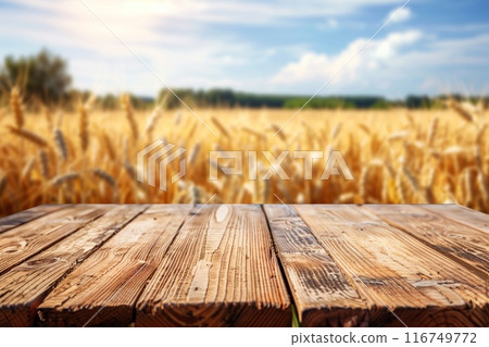 Wooden table surface in front of a blurred wheat field during summer, great for seasonal advertising or agribusiness content. 116749772