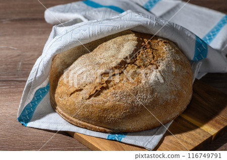 homemade whole grain bread in the kitchen on a wooden table 5 116749791
