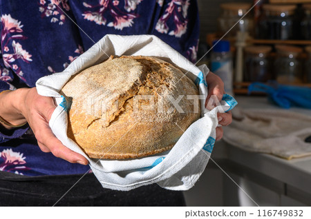 Woman holding homemade whole grain bread in her hands 1 Woman holding homemade whole grain bread in her hands 1 116749832