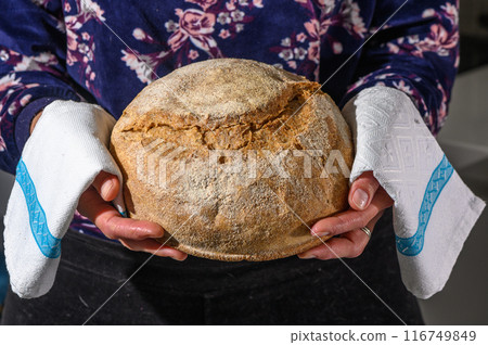 Woman holding homemade whole grain bread in her hands 5 Woman holding homemade whole grain bread in her hands 5 116749849