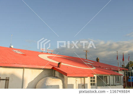 the house is painted red and white and the Turkish flag is painted on the house 4 116749884