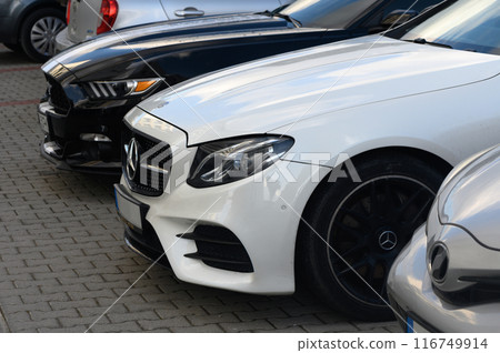Gaziveren Cyprus 14/03/2024 - white Mercedes and black and white Ford Mustang front and side views 116749914