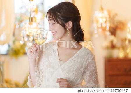 Young woman drinking alcohol at a party Young woman drinking alcohol at a party 116750487