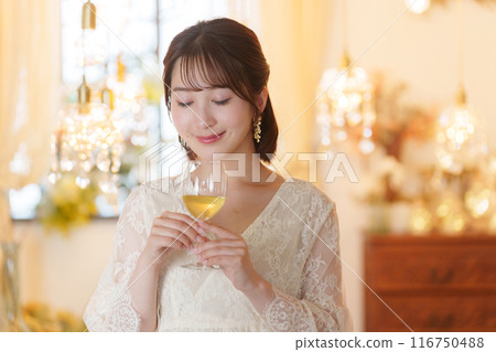 Young woman drinking alcohol at a party 116750488