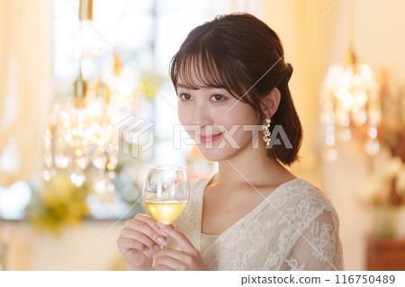 Young woman drinking alcohol at a party 116750489