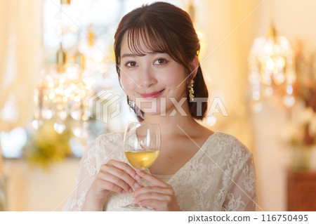 Young woman drinking alcohol at a party Young woman drinking alcohol at a party 116750495