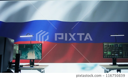 Empty army command center monitoring room agency with the russian flag on big screen, spreading propaganda messages and fake news to scare people. Military Russian federation power. Camera B. 116750839