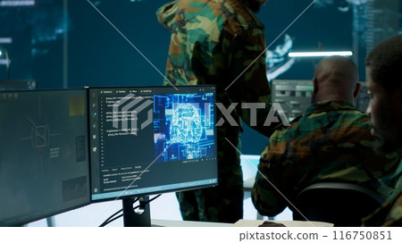 IT software engineer collecting real time data from neural network AI brain, machine learning and data mining algorithms to assist troops with defense missions. Cognitive computing. Camera A. IT software engineer collecting real time data from neural network AI brain, machine learning and data mining algorithms to assist troops with defense missions. Cognitive computing. Camera A. 116750851