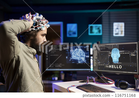 Man placing EEG headset on head to communicate with artificial intelligence entity with anthropomorphic body. Software programmer using high tech gear to talk with AI robot in humanoid form 116751168