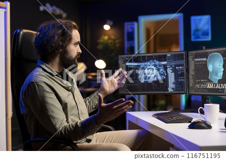 Programmer having shocked expression on face after being asked existential questions by awaken AI on PC. Confused IT specialist bewildered by artificial intelligence able to speak on its own 116751195