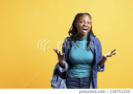 Portrait of BIPOC girl feeling outraged, being hysteric, isolated over studio background. Livid teenager having mental breakdown during burnout, throwing tantrum, complaining 116751250