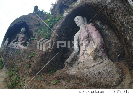 Akauk Taung has a Buddha image carved in sandstone on the Akauk Mountain cliff along the Ayeyavadee River near Htonbo village. Magway Region.Myanmar. 116751812