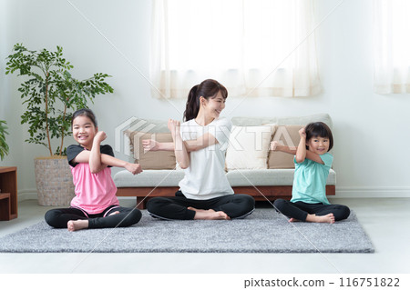 Parents and children stretching in the living room 116751822