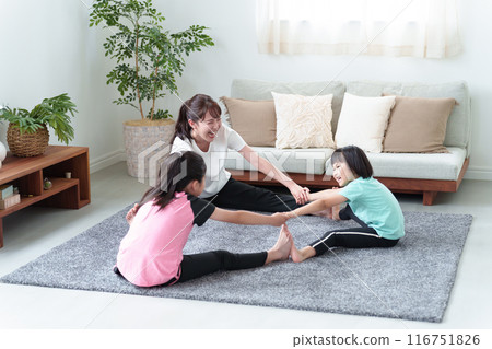 Parents and children stretching in the living room 116751826