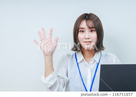A young female staff member making a par with her right hand A young female staff member making a par with her right hand 116751857