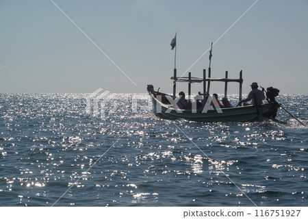Silhouette of a fishing boat on a sea at Ngapali Beach which is the daily routine the occupation of the villagers here . Silhouette of a fishing boat on a sea at Ngapali Beach which is the daily routine the occupation of the villagers here . 116751927