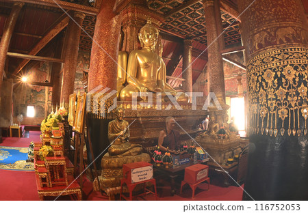 Four Buddha statues in the posture of Maravichai, facing out to the gates in all four directions, with bases built inside Buddhist Church at  Wat Phumin. 116752053