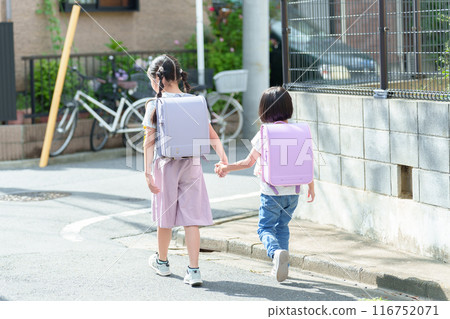 Back view of a girl going to and from school Back view of a girl going to and from school 116752071