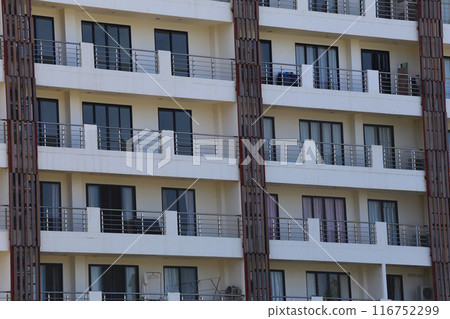 Close up of tall building with a skyscraper background. Close up of tall building with a skyscraper background. 116752299