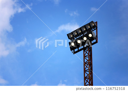 Big light pole on the blue sky background. 116752318
