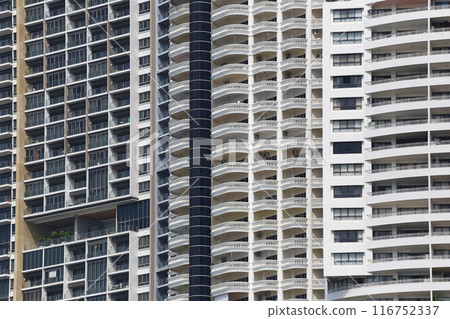 Close up of tall building with a skyscraper background. Close up of tall building with a skyscraper background. 116752337