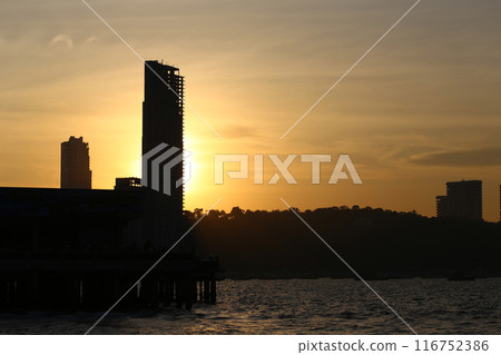 Silhouette picture of Tall buildings and mountains in the evening sun is about to set. Silhouette picture of Tall buildings and mountains in the evening sun is about to set. 116752386