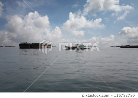Tug boats and cargo ships moored in the bay of Koh Sichang. Tug boats and cargo ships moored in the bay of Koh Sichang. 116752750