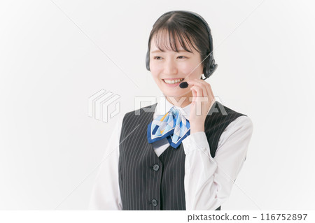 A woman in office clothes wearing a headset A woman in office clothes wearing a headset 116752897