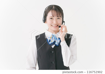 A woman in office clothes wearing a headset A woman in office clothes wearing a headset 116752902