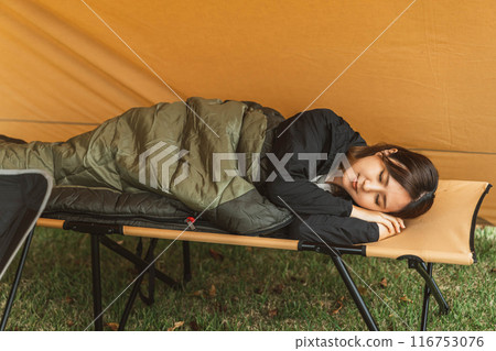 A young female camper sleeping in a sleeping bag / sleeping bag at a campsite (sleep) 116753076