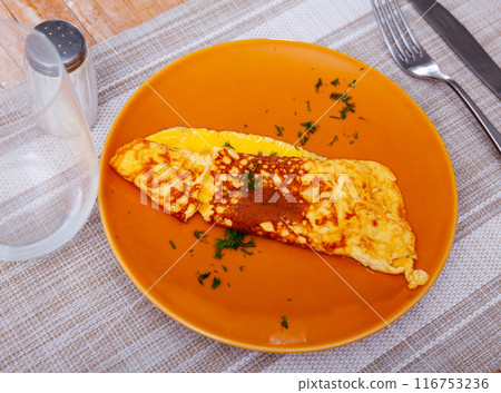 Thin omelette served with bread for breakfast close up 116753236
