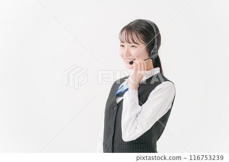 A woman in office clothes wearing a headset A woman in office clothes wearing a headset 116753239