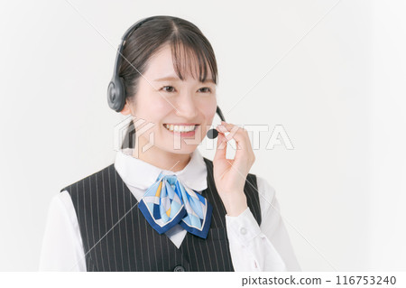 A woman in office clothes wearing a headset 116753240
