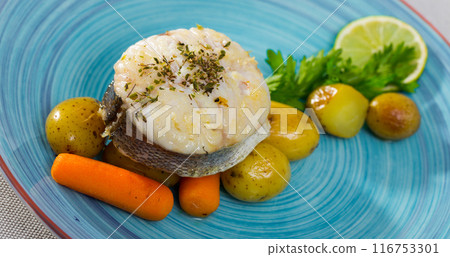 Cod by rustically frying and served with boiled potatoes, carrots and greens 116753301