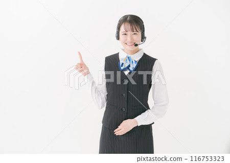 A woman in office clothes wearing a headset A woman in office clothes wearing a headset 116753323