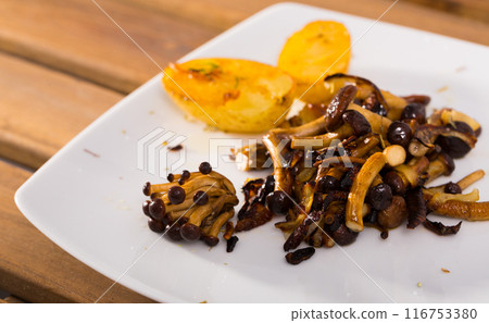 Delicious cooked fried shitake mushrooms with young potatoes 116753380
